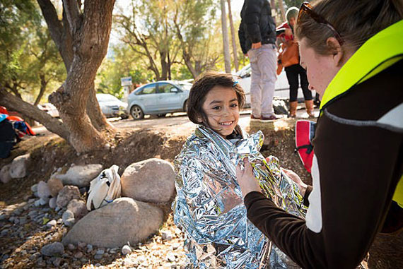 Young girl smiles with disaster relief professional